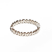 Silver ring with a Dollars design on a white background