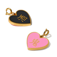 A reversible pendant with one side black and the other pink, both featuring a gold heart shape and Chinese characters 酒 , attached to a gold plated clasp.