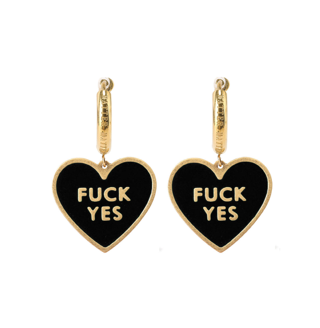 A pair of black heart-shaped earrings with the phrase 'FUCK YES' written in white letters, attached to gold-colored hoop earrings.