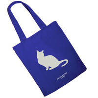 A blue cotton tote bag with the text 'Less people, more cats' printed on the front side, featuring a silhouette of a cat.