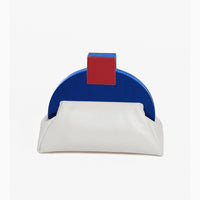 A beige clutch with a geometric blue and red design on the front, closed with a red clasp.