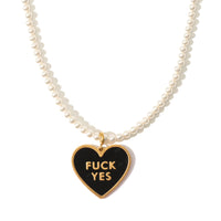 A white pearl necklace with a black enamel pendant that reads 'FUCK YES' on a gold-plated stainless steel chain.