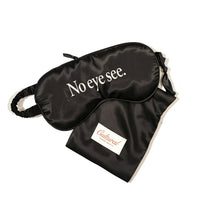 Black sleep mask with 'No eye see.' text and a matching pouch on a white background