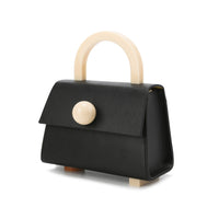 Black satchel bag with a resin handle and a detachable shoulder strap, featuring asymmetric resin studs at the bottom.