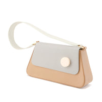 A MATTER MATTERS brown flap shoulder bag with a wide strap and a leather shoulder strap, featuring a matt gold D ring and resin stud. The bag has a cotton-twill interior with a magnetic flap closure.