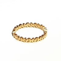 Gold ring with a dollars 
design on a white background