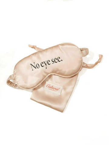 Beige sleep mask with 'No eye see.' text on a white background