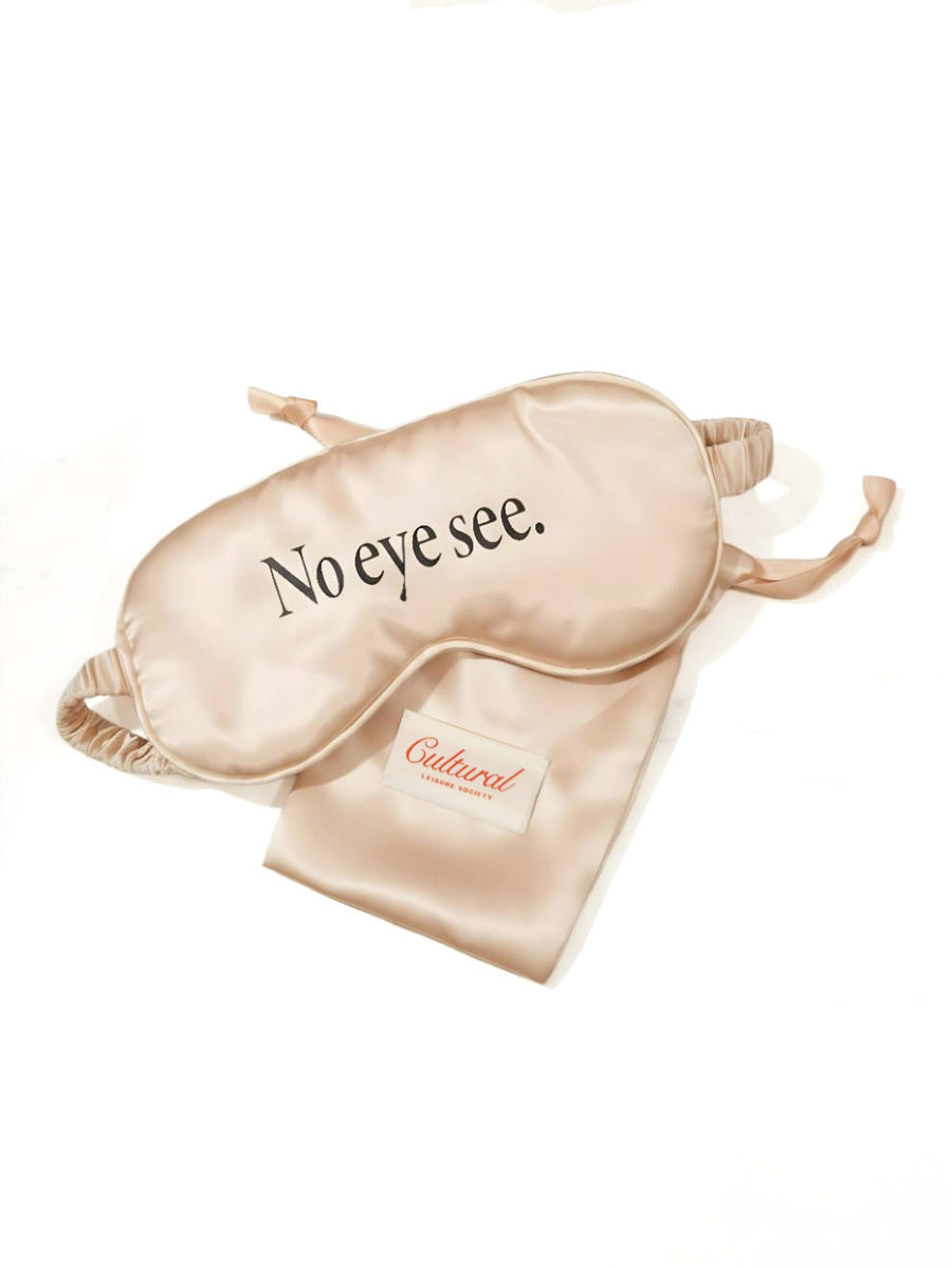 Beige sleep mask with 'No eye see.' text on a white background
