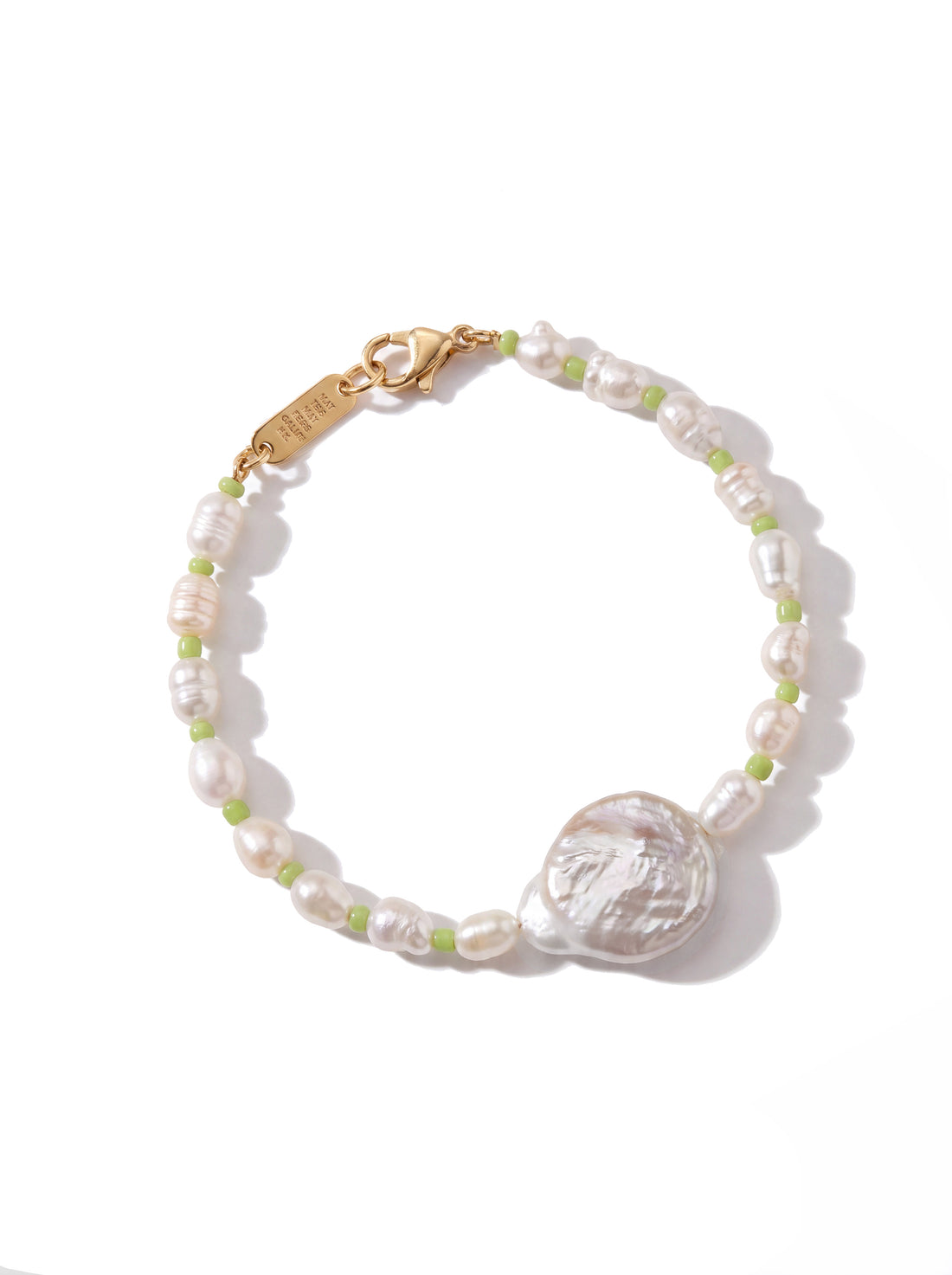 A delicate beaded bracelet featuring irregular white baroque pearls, small light green beads, and a large textured white shell centerpiece, finished with a gold-tone lobster clasp. The brand name 'SARABAR' is engraved on the clasp.