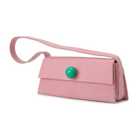 Pink handbag with a green button on a white background